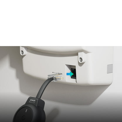 Cable being plugged into a wall socket with a close-up of the cable label.
