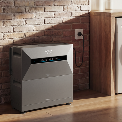 Anker air purifier next to a washing machine in a laundry room with brick wall.